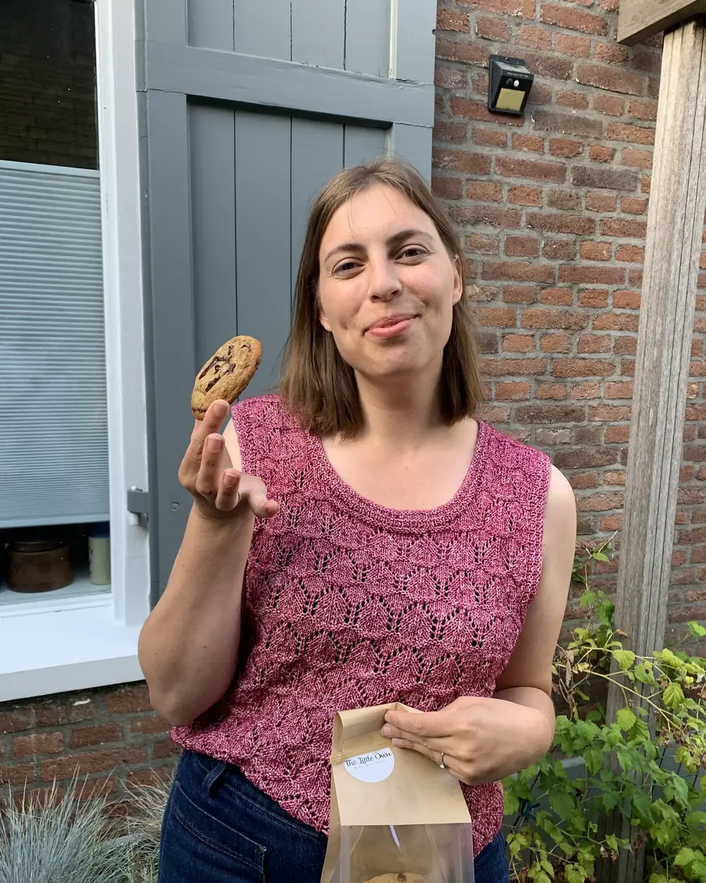 Demi van The Little Oven met een verse cookie en een zakje koekjes